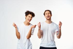 emotional two friends in white t-shirts yes fun studio photo