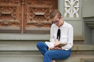 short haired woman with a book in his hands outdoors reading communication photo