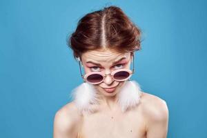 woman with bare shoulders sunglasses fashion blue background photo