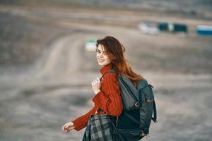 woman hiker in mountains travel with backpack landscape photo