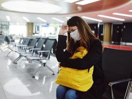 woman in medical mask airport waiting passenger photo