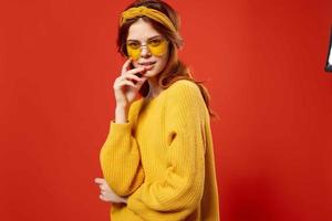 cheerful woman studio smile emotions yellow glasses red background photo