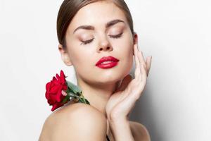 Woman with rose With closed eyes, holds a hand near the face cute face photo