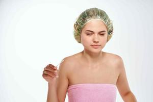 emotional woman with pink towel bare shoulders and skin problems dermatology photo