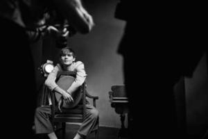 guy sitting on a chair next to the piano posing photo