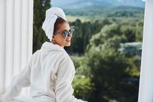 beautiful woman in a bathrobe in the morning on the balcony admiring nature Mountain View photo