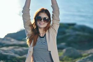 cheerful woman wearing sunglasses travel walk summer freedom photo