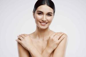 pretty woman with bare shoulders and clean skin close-up cosmetics photo