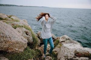 woman freedom walk on the stone coast Lifestyle photo