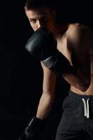 boxer in black gloves lean forward on isolated background cropped view photo