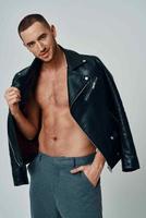man in black leather jacket topless posing modern style self-confidence photo