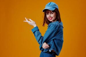 Positive young woman denim clothing fashion posing cap color background unaltered photo