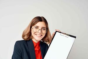 emotional business woman in suit folder with papers manager office light background photo