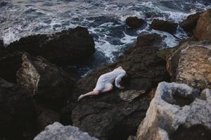 sensual woman in white wedding dress on sea shore wet hair Summer vacation concept photo