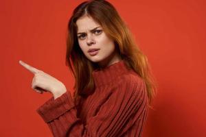 pretty red-haired woman in red sweater fashion posing close-up photo