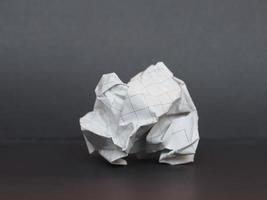 white paper ball over dark gray background photo