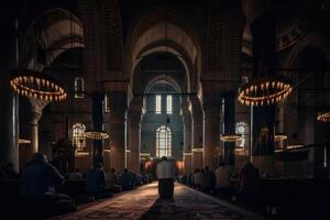 Rear view of a man praying in a Muslim mosque. Huge Arabian architecture with beautiful ceiling rose light. Muslims are praying in a huge mosque. Islamic holy place rear view. . photo