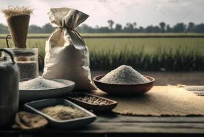 White rice or uncooked white rice in wooden bowl and sack with rice field background. photo