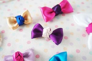 Colorful bow tie on white fabric with polka dot background. photo