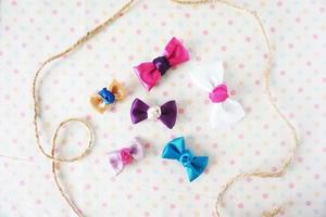 Colorful bow tie on white fabric with polka dot background. photo