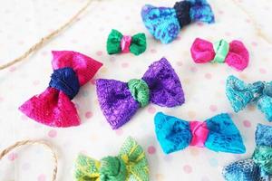 Colorful bow tie on white fabric with polka dot background. photo