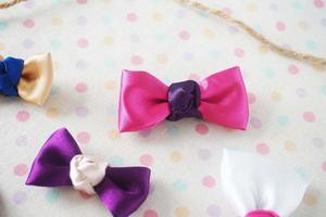 Colorful bow tie on white fabric with polka dot background. photo