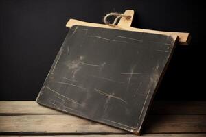 Illustration of a chalkboard with a wooden handle on a wooden table created with technology photo