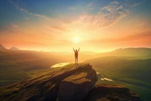 Free on top of a mountain, arms raised photo