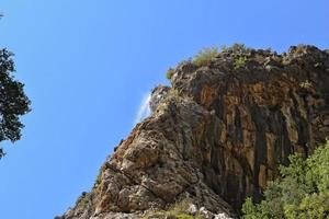 a natural wild landscape in the Turkish mountains with an interesting waterfall and the sapadere canyon photo