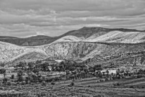 empty mysterious mountainous landscape from the center of the Canary Island Spanish Fuerteventura with a cloudy sky photo