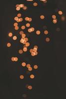 orange background festive bokeh light effect on dark background photo