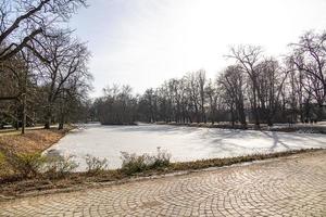 landscape with a frozen lake in the park in Warsaw in Poland on a sunny winter day photo