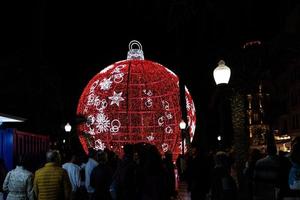 big glowing red bauble Christmas decoration in Alicante, Spain at night photo