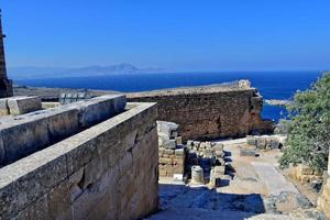 old antique stone ruins on a hot summer day on the Greek island of Rhodes in Lindos photo