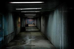 abandoned urban underground passage with graffiti on the wall photo