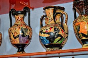 handmade clay dishes in the Greek style in the shop at the potter's workshop photo