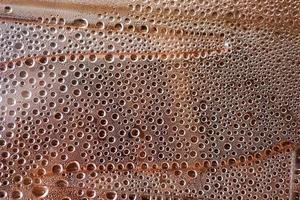 small drops of water on a beige background in close-up photo