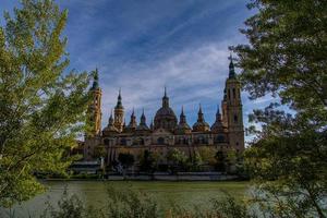 spring urban landscape with pillar cathedral in Zaragoza, spain and the Ebro river photo