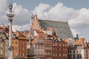 landscape from the square of the old town of Warsaw in Poland with the royal castle and tenement houses photo