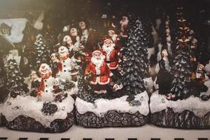 Christmas decorations with moving figurines on a winter background photo