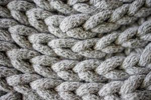 interesting background made of crochet hand-made, gray cotton cord photo