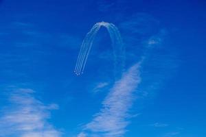 flight of five cessna planes over alicante smoke spanish flag against the blue sky photo