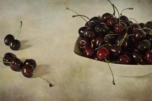 l juicy fresh summer cherries in a white bowl on a vintege background photo