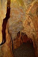 interesting original cave in the Turkish mountains with stalactites and stalagmites creating the background photo