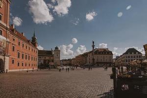 landscape from the square of the old town of Warsaw in Poland with the royal castle and tenement houses photo