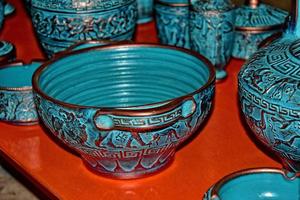 handmade clay dishes in the Greek style in the shop at the potter's workshop photo