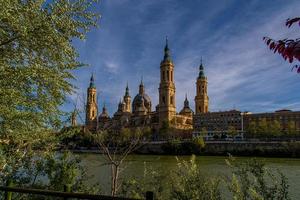 spring urban landscape with pillar cathedral in Zaragoza, spain and the Ebro river photo