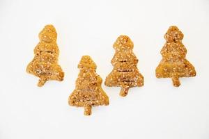 sweet cakes with sugar and cinnamon in the shape of a Christmas tree on a white isolated background photo