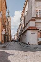 historic street with old tenement houses in the Warsaw Old Town in Poland on a summer day photo