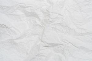 Wrinkled or crumpled white stencil paper or tissue after use in toilet or restroom with large copy space used for background texture in art work photo